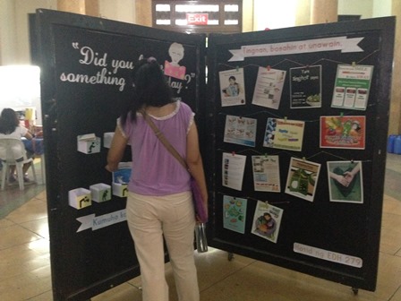 A student reads helpful health information posted during HAPI days 2015